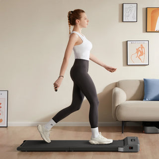 Woman walking on the WalkingPad Z1 treadmill in a living room
