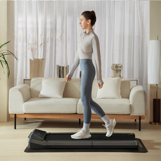 Woman walking on the WalkingPad Z3 Just Walk treadmill in a bright living room