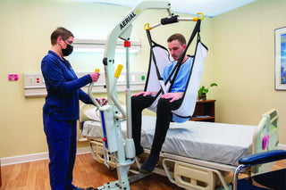 Wy'East Medical Aerial 51870 caregiver transferring a seated patient in a highback sling