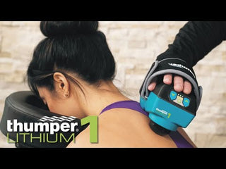 Thumper Lithium1 cordless percussion massager with a wearable glove-style hand strap in black and teal.