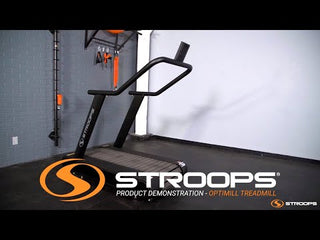 A black flat self-propelled motorless treadmill with a low-profile steel frame, slatted running belt, front support handles, and a vertical steel spine positioned behind the treadmill. The system can be configured with optional resistance training accessories including the Base Slastix® Adjustable Anchor, Universal Swivel Belt XL, and Optitail® Anchoring System for performance training and rehabilitation applications.