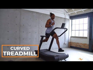The Stroops OPTICURV is a commercial-grade curved motorless treadmill with a black steel frame and a curved, slat-style running surface. The treadmill features front support handles, a digital performance monitor, integrated transport wheels, and a self-powered design that allows users to control speed naturally without electricity, making it suitable for indoor running, sprint training, walking, and rehabilitation.